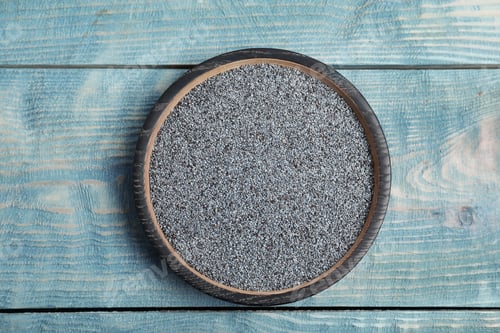 Preview: Poppy seeds in plate on wooden background, top view