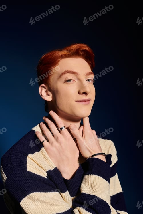 Preview: Emotional young man with striking red hair showcases confidence in artistic portrait