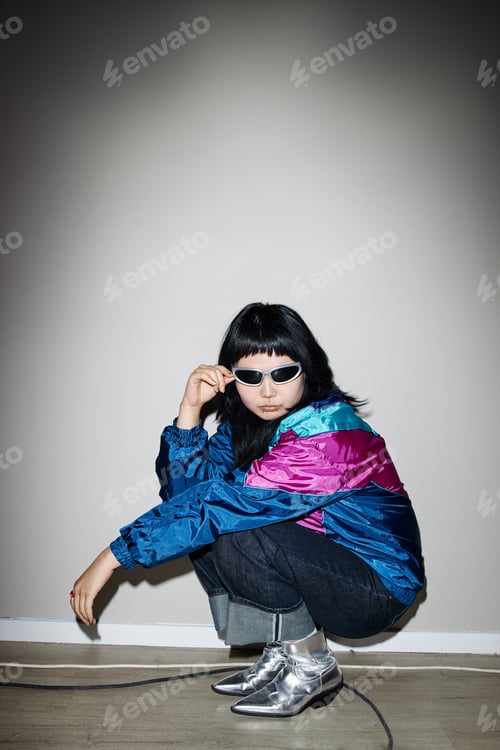 Preview: Young Adult Asian Woman Wearing Sunglasses Squatting Indoors Second Hand Shop