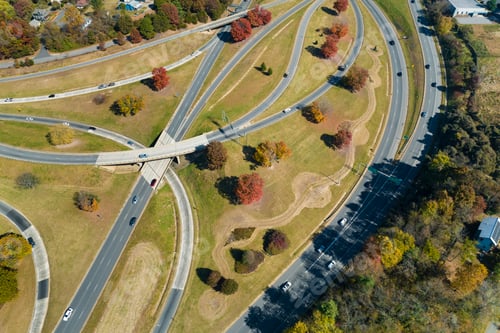 Preview: Aerial view of american freeway intersection with fast moving cars and trucks.