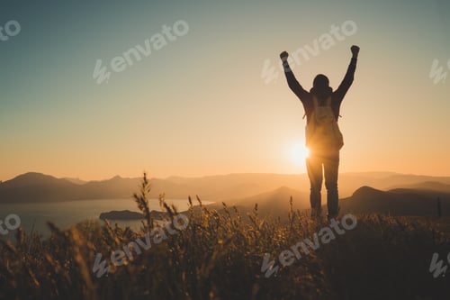 Preview: Young standing man with backpack. over sunset in nature