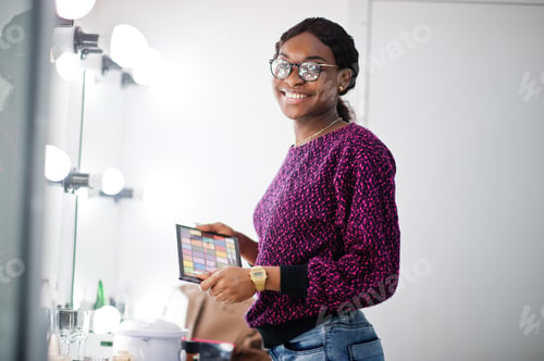 Preview: African American woman applying make-up