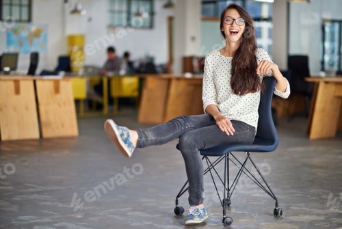 Preview: Its a chilled place to work. Portrait of an attractive young woman sitting in an office.