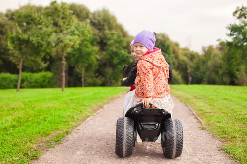 Preview: Happy little cute girls ride a motorbike outside