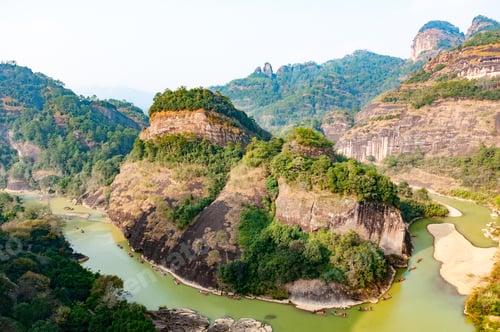 Preview: Beautiful Danxia landform. Many people rafting on bamboo rafts in a winding river in Wuyi Mountain.