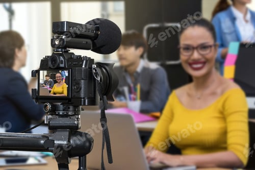 Preview: Woman Filmed in Office with Coworkers in Background