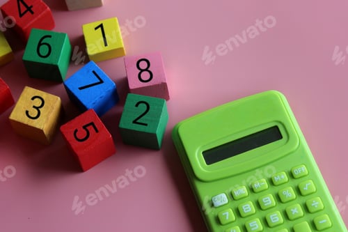 Preview: Calculator and a wooden cubes with mathematical symbol