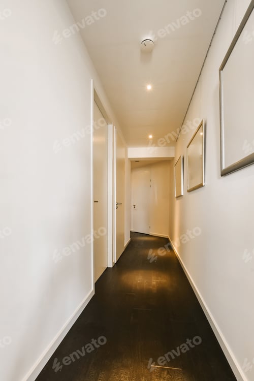 Preview: a long hallway with white walls and a black floor