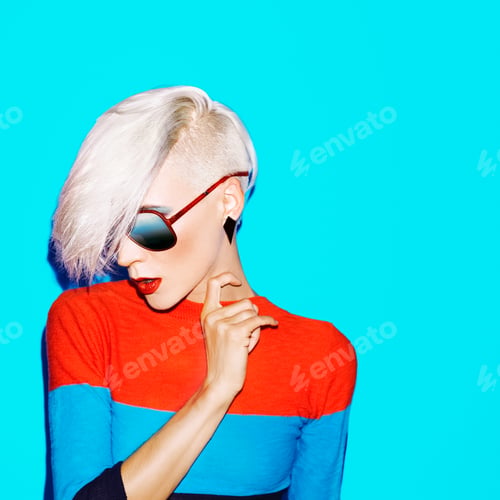 Preview: fashion blond woman with trendy hairstyle and sunglasses on a bl