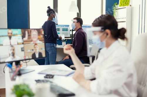 Preview: Man discussing with african coworker about a project at workplace