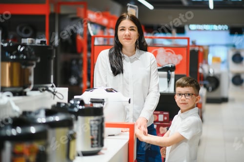 Preview: Happy mother with son in home appliance store.