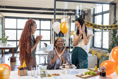 Preview: Colleagues celebrating birthday at office with balloons, cupcakes, and laughter