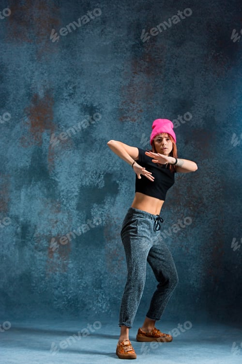 Preview: Young girl break dancing on wall background.