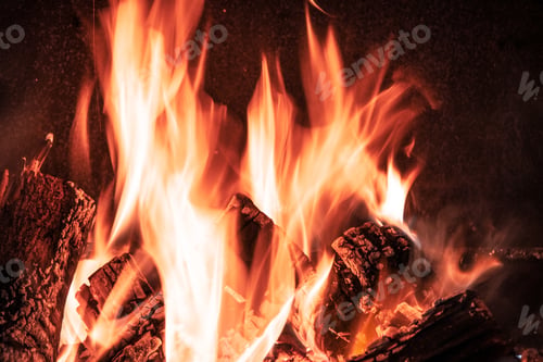 Preview: Fire orange tongues on black background in a brick fireplace