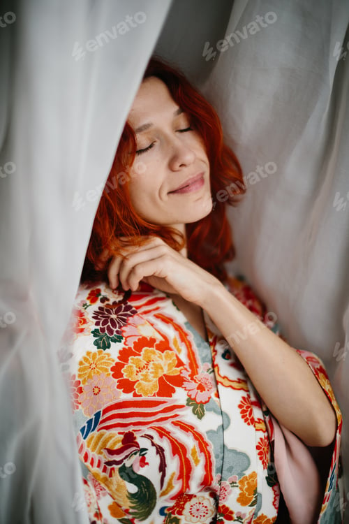 Preview: Woman relaxing in vibrant kimono with closed eyes