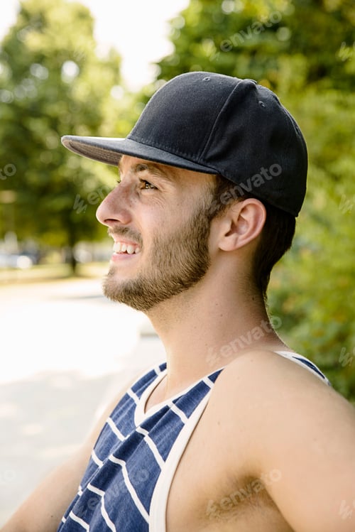Preview: Young male basketball player taking a break in park