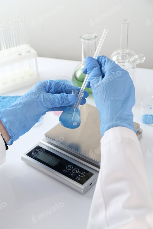 Preview: Scientist working with sample and scales at white table, closeup