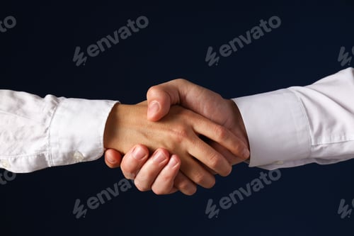 Preview: Male handshake close-up on a dark background