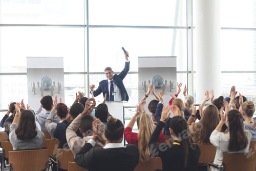 Preview: Diverse business people applauding a businessman at business seminar
