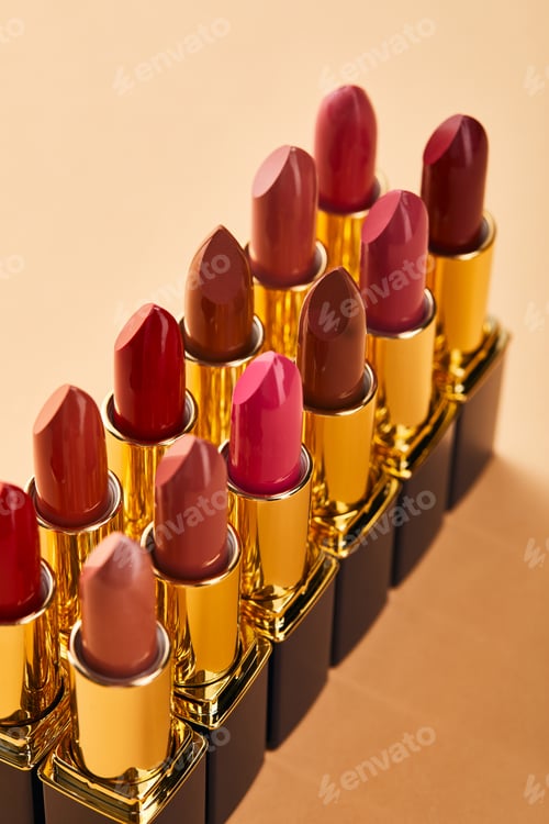 Preview: different red shades of lipstick in tubes on beige