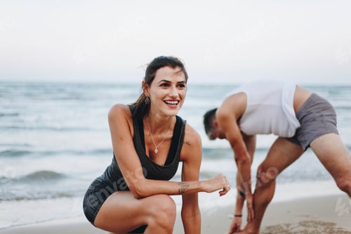 Preview: Couple stretching at the beach