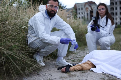 Preview: Forensic experts working at crime scene with dead body outdoors