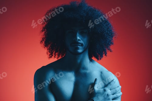 Preview: Portrait of fashion man with curly hair on red background with stylish glasses, multinational