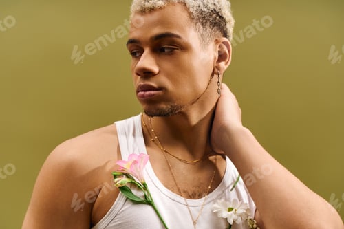 Preview: Young man radiates style in trendy tank top with flowers in studio setting