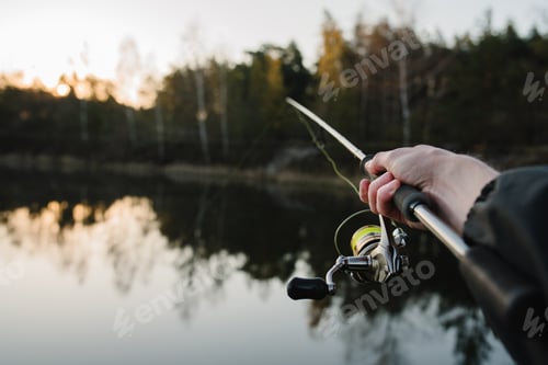 Preview: Fishing. Fisherman with rod, spinning reel on the river bank. Fishing for pike, perch, carp. Fog