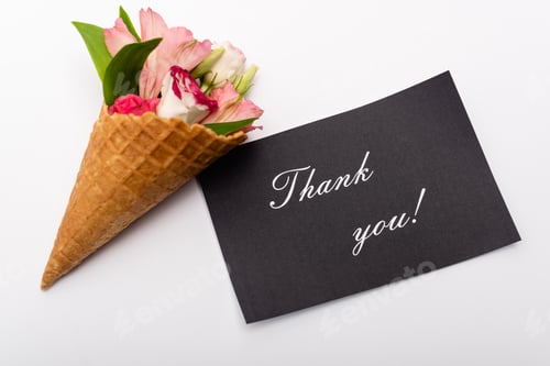 Preview: top view of flowers in waffle cone near card with thank you lettering on white