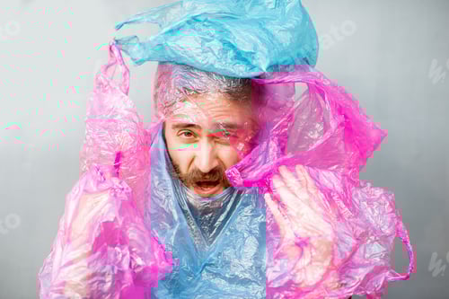 Preview: Conceptual portrait of a man covered with plastic bags