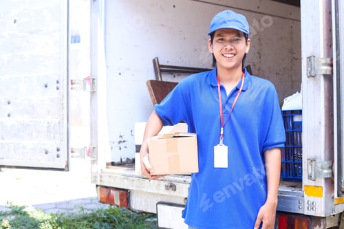 Friendly Delivery Worker Smiling with a Package