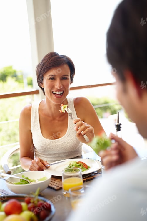 Preview: Good food, good mood. Shot of an attractive woman having lunch with an unrecognizable person.