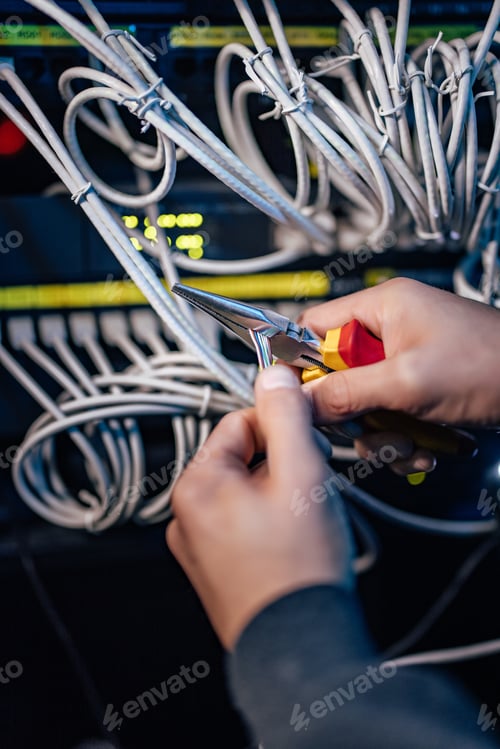 Preview: Working on setting up the ethernet network. Using long-nose pliers.