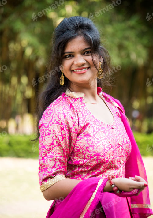 Preview: Outdoor portrait of beautiful young Indian girl in traditional dress.