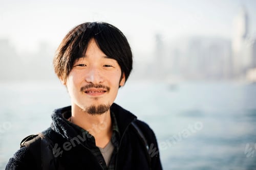 Preview: Portrait of mid adult man with goatee and mustache looking at camera smiling