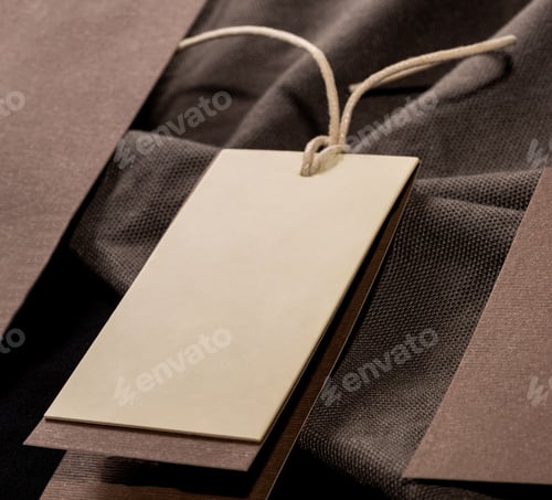 Preview: Closeup shot of a blank clothing tag on a string for a price label on a cloth