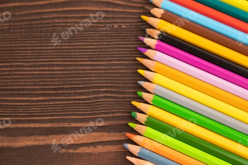 Preview: Set of watercolor pencils on brown wooden. Top view, copy space
