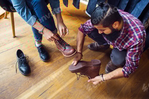 Preview: Woman trying on shoes with friend in store
