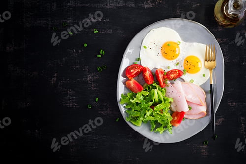 Preview: Ketogenic/paleo diet. Fried eggs, ham and fresh salad. Keto breakfast. Brunch. Top view, overhead