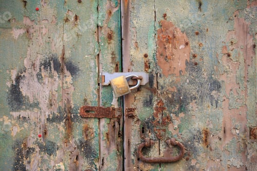 Preview: Wooden peeled door background locked with rusty handle and padlock. A