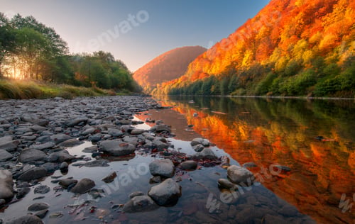Preview: Lake in mountains with red and orange trees at sunset in autumn