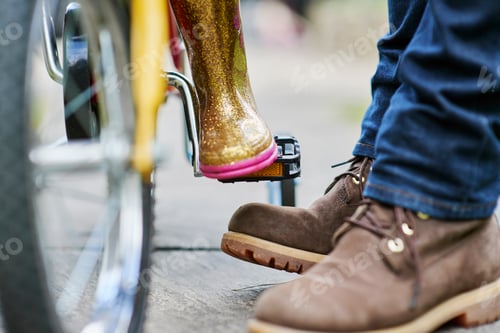 Preview: Feet of father and daughter with bicycle