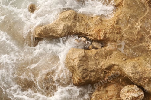 Preview: A close-up shot of the Mediterranean Sea turquoise water and powerful waves beating against the rock