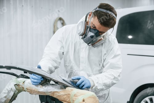 Preview: Metal carcass. Repairman is working in the garage