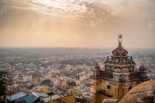 Preview: Roof of the ancient temple in Trichy India with the cityscape in the sunny background