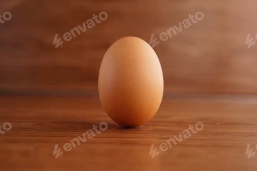 Preview: Of an egg on a wooden surface with a blurred background