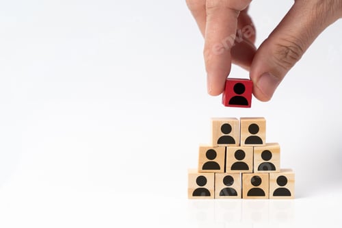 Preview: Human resource management concept by hand putting wood cube block leader on top pyramid.