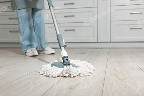 Preview: Woman cleaning floor with mop at home, closeup. Space for text