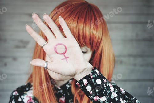 Preview: Young feminist with a female sign in her hand